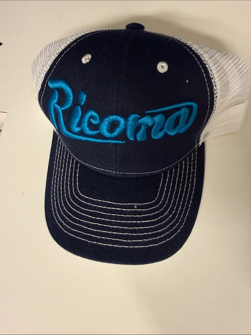 Navy and White Mesh Trucker Hat with Teal Script Logo